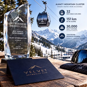 Shymbulak's 2026 SKI BUSINESS AWARDS trophy for Velvet Shymbulak Club with a gondola and snowy Almaty mountains in the background, alongside Almaty Mountain Cluster expansion plans.